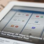 a tablet shows an article about Trello